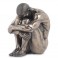 Figurine en resine Homme assis avec tete sur ge